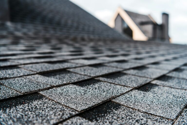 selective focus of grey shingles on rooftop of building