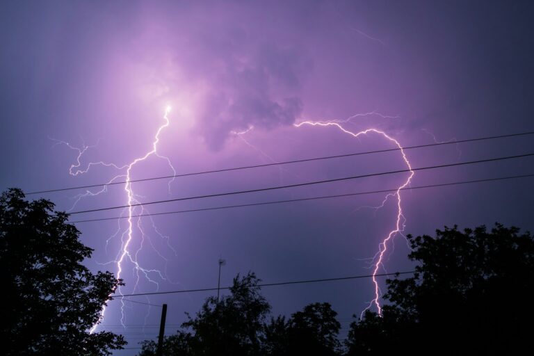 Thunderbolt over the house and dark stormy sky on the background